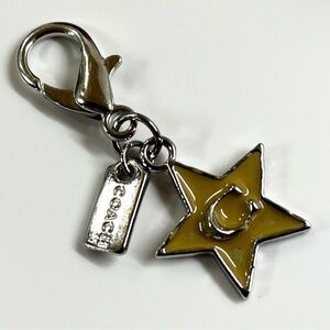 Coach mini bag charm keychain featuring a yellow star with a "C" logo EUC